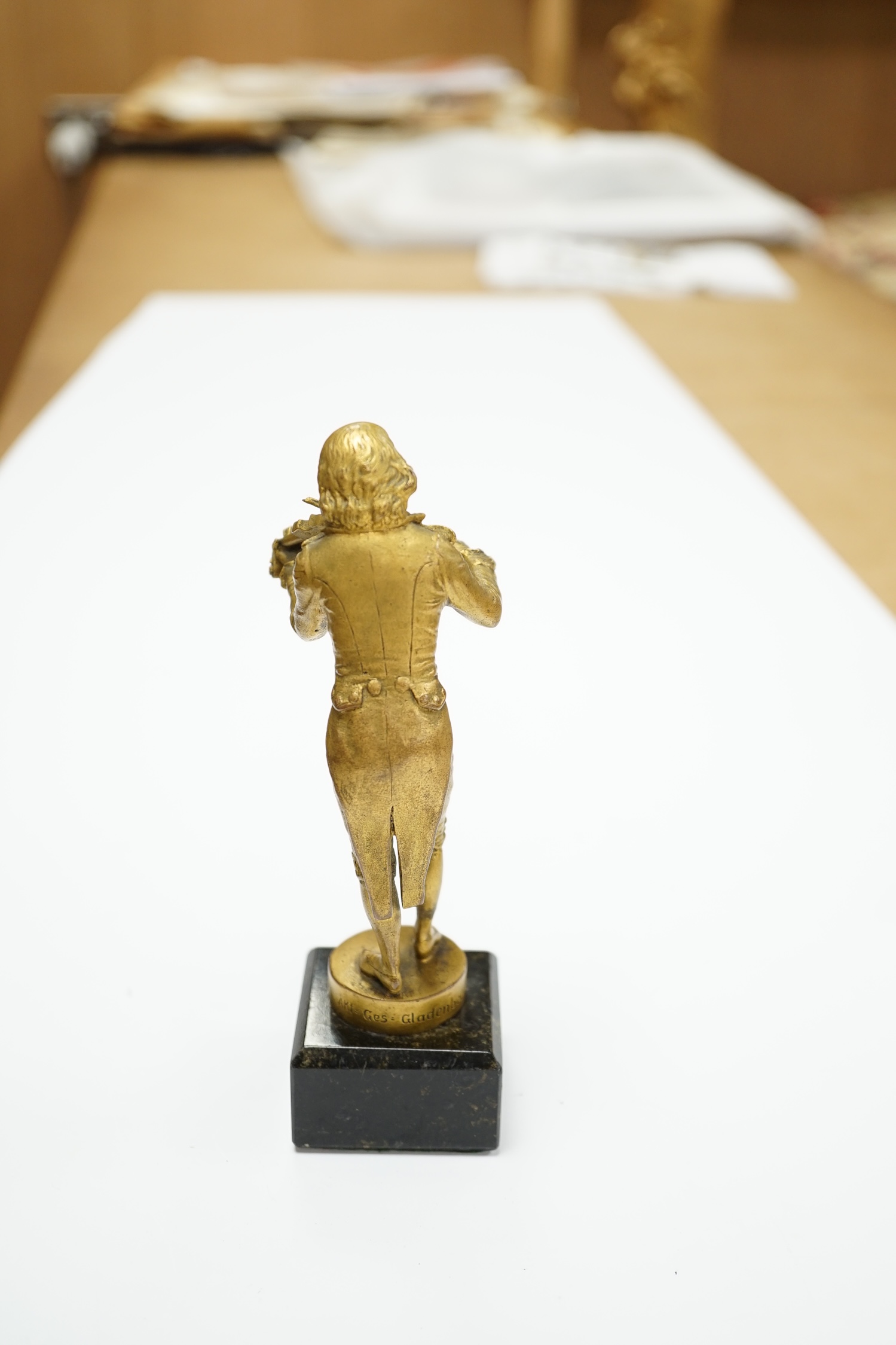 An ormolu bronze of a violinist on a marble base, signed Aktien-Gesellschaft Gladenbeck, Berlin, 14cm high